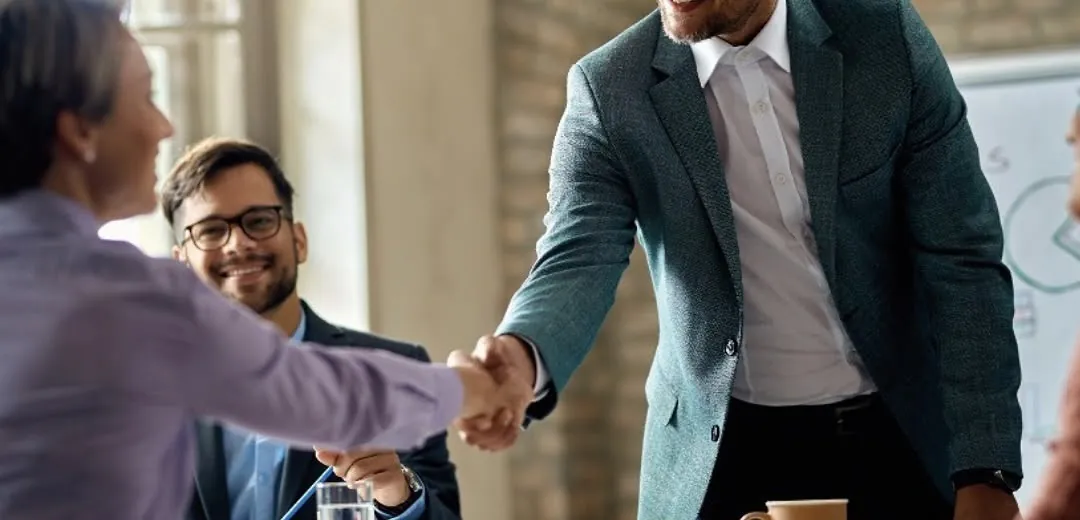 Reunión de trabajo cerrando un acuerdo con un apretón de manos